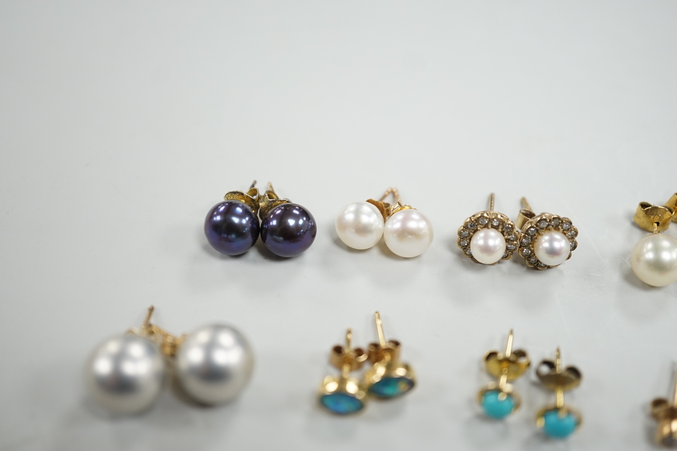 Eight assorted modern pairs of ear studs, including a 14k and cultured pearl and two other cultured pearl, one 9ct and diamond chip.